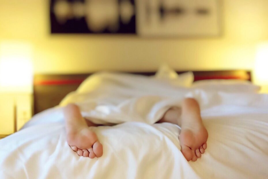Bare feet sticking out from under the duvet